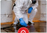 Cleanup professional in protective equipment working on a contaminated floor